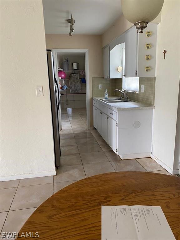 106 Jasmine Road West Lehigh Acres, FL 33936 - Photo 5 of 7 a view of a kitchen from the hallway