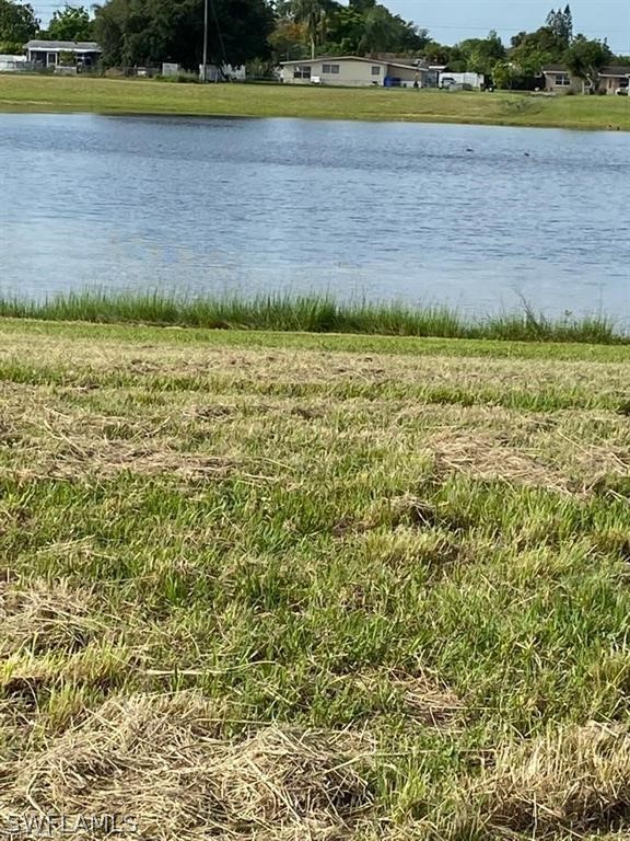 106 Jasmine Road West Lehigh Acres, FL 33936 - Photo 6 of 7 a view of a swimming pool and a yard