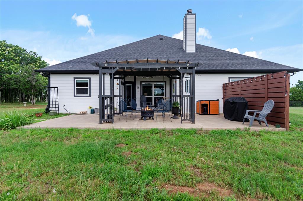 6093 Farm To Market Road 730 North Decatur, TX 76234 - Photo 23 of 28 a view of a house with a backyard patio and a garden