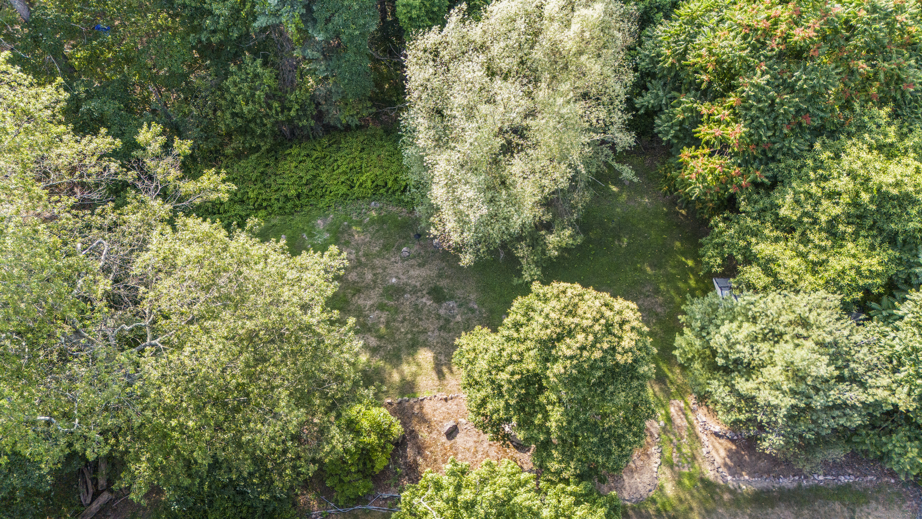 1378 Shepard Avenue Hamden, CT 06518 - Photo 15 of 15 a backyard of a house with lots of green space and trees all around