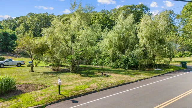 an aerial view of residential houses with outdoor space and trees