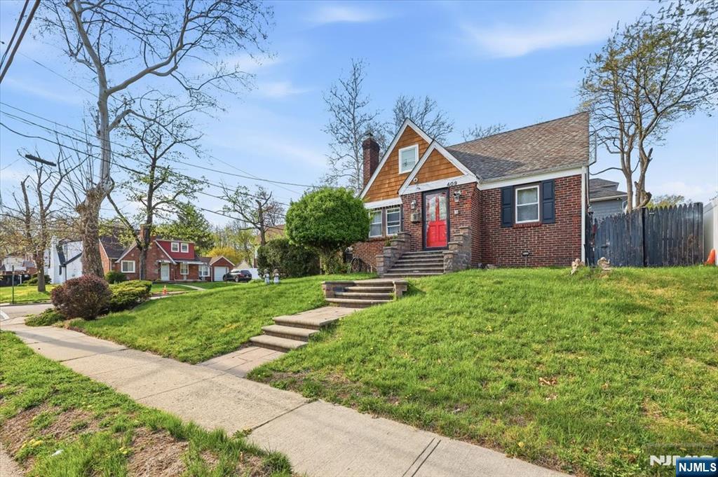 409 Tryon Avenue Englewood, NJ 07631 - Photo 2 of 33 a front view of house with yard and green space