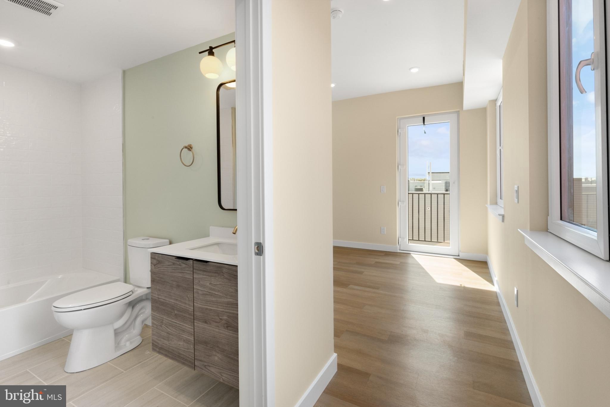 1701 South 4th Street, Unit 407 Philadelphia, PA 19148 - Photo 4 of 31 a bathroom with a toilet a sink and shower