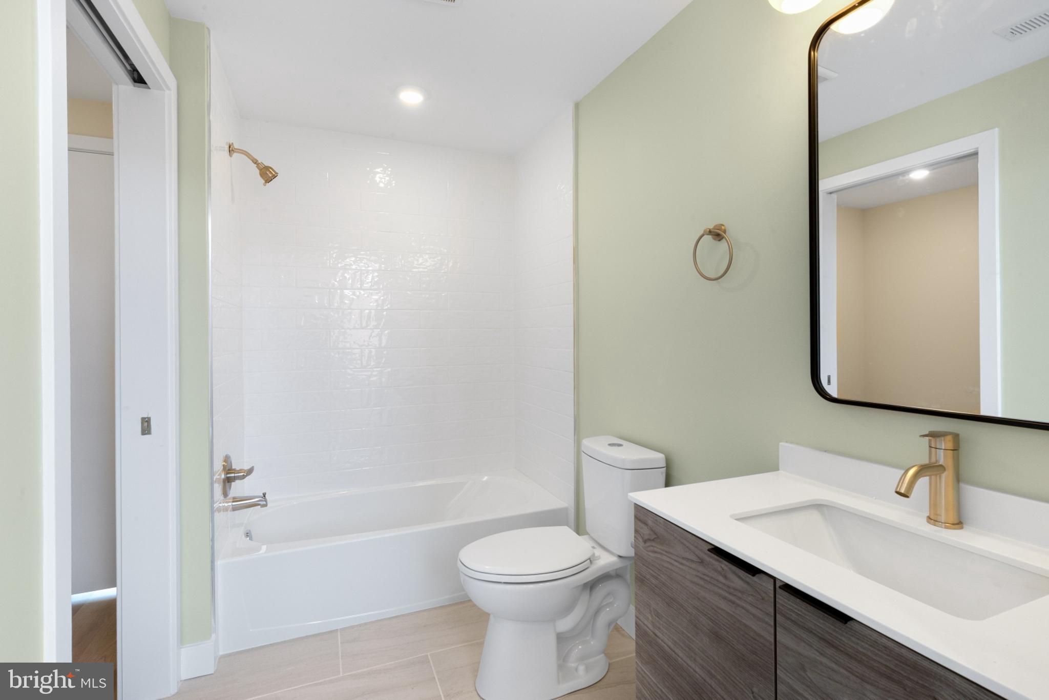 1701 South 4th Street, Unit 407 Philadelphia, PA 19148 - Photo 5 of 31 a bathroom with a granite countertop sink toilet and shower