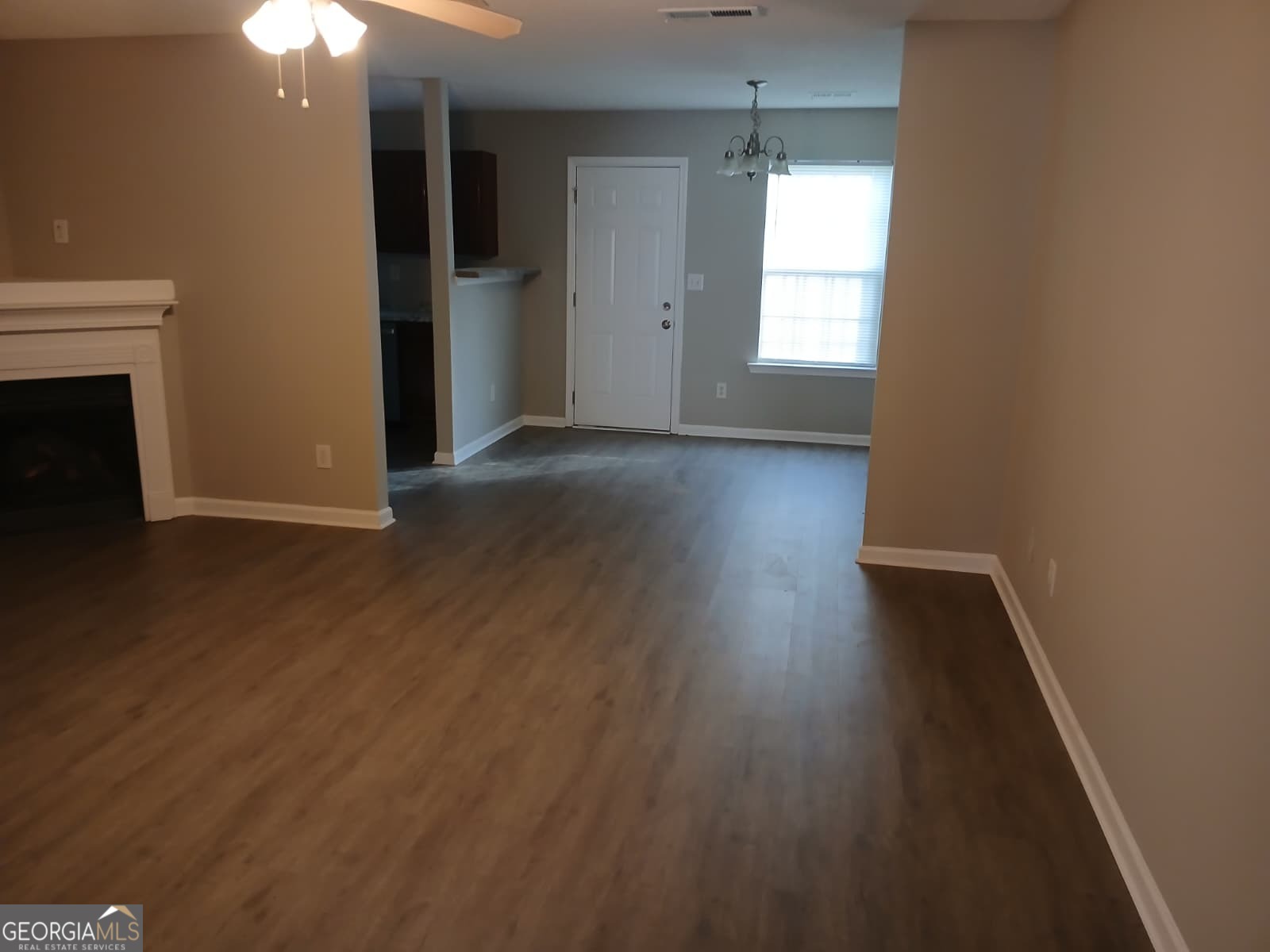 5190 Hanover Street Atlanta, GA 30349 - Photo 17 of 20 an empty room with wooden floor and windows