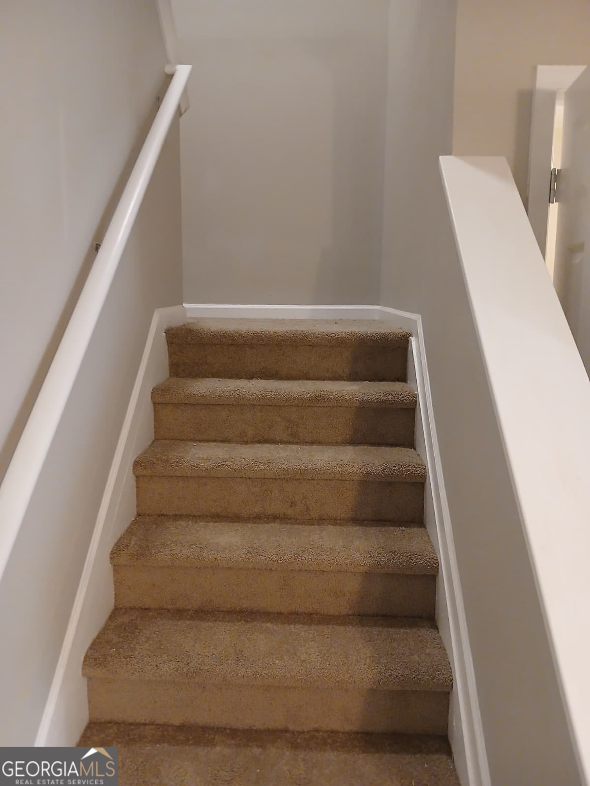 5190 Hanover Street Atlanta, GA 30349 - Photo 20 of 20 a view of staircase with white walls and white door