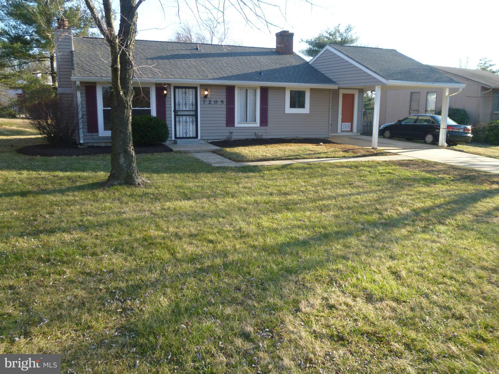 7205 Johnnycake Road Baltimore, MD 21228 - Photo 2 of 14 a house that has a big yard plants and large trees