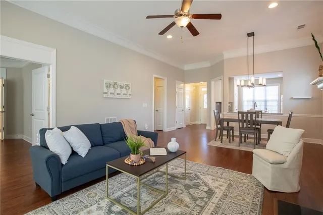 a living room with furniture and wooden floor