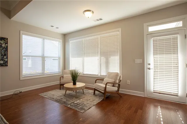 a living room with furniture and floor to ceiling windows