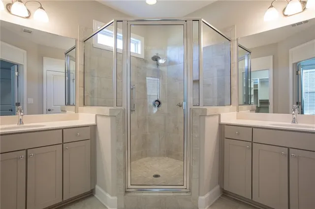 a bathroom with a shower sink and mirror