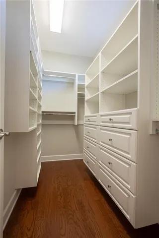 a view of walk in closet with empty racks