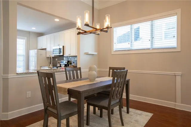 a view of a dining room with furniture window and wooden floor