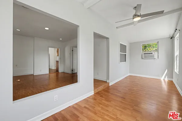 a view of a hallway with wooden floor