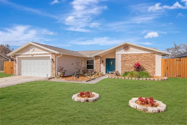 a front view of a house with a big yard