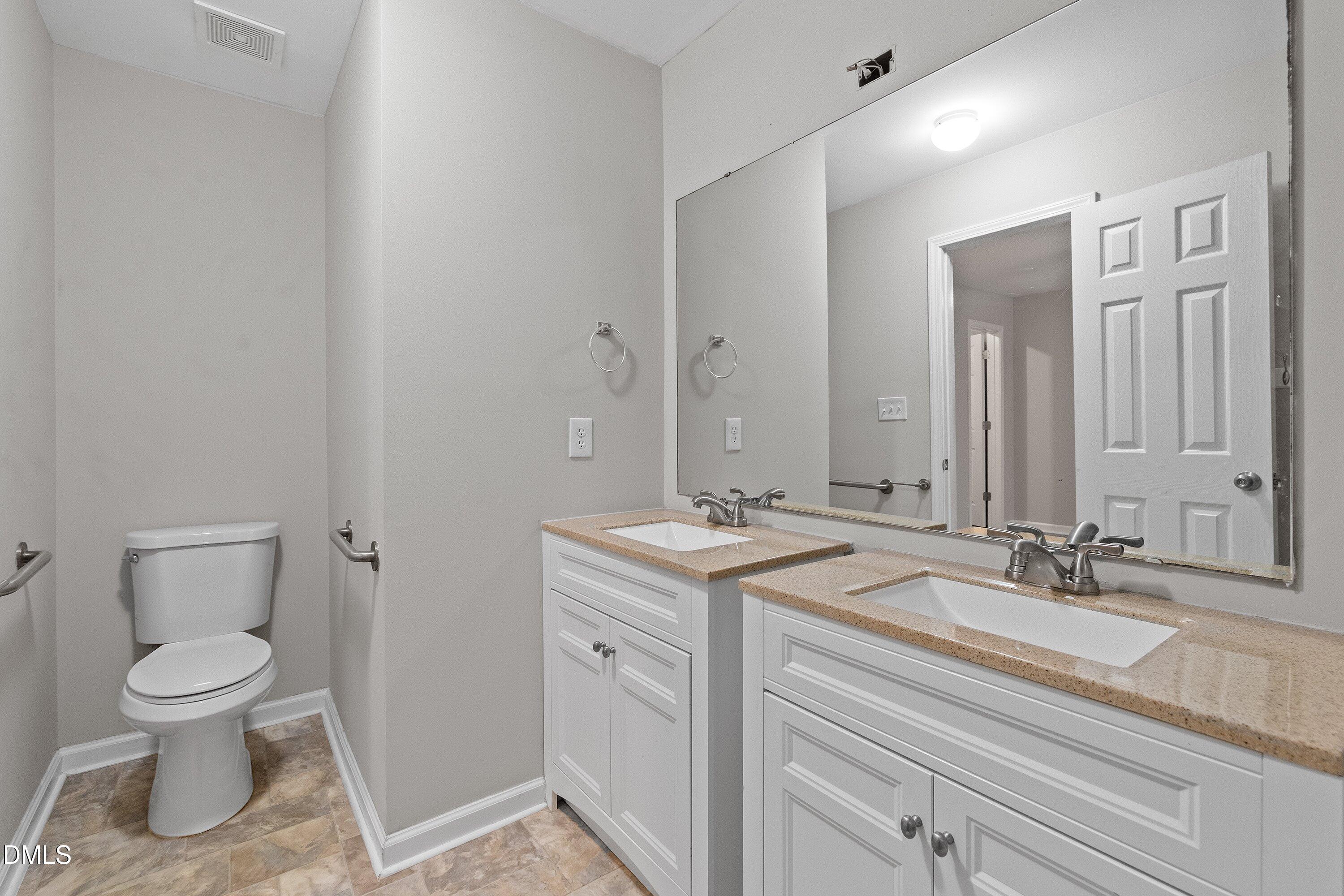 140 Melksham Road Wake Forest, NC 27587 - Photo 24 of 34 a bathroom with a toilet sink and mirror