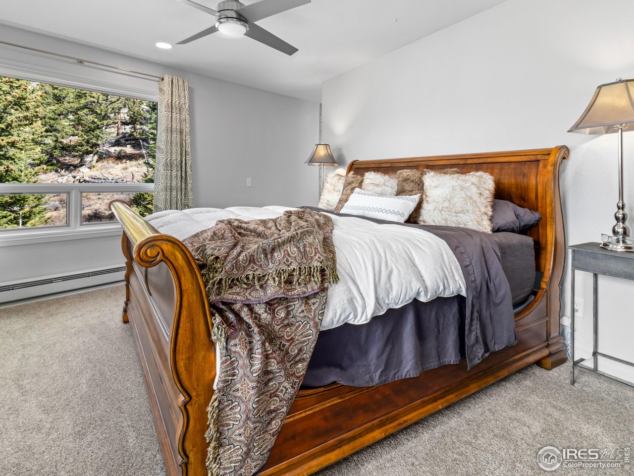 1267 Upper Venner Road Estes Park, CO 80517 - Photo 10 of 44 a bedroom with a bed and window