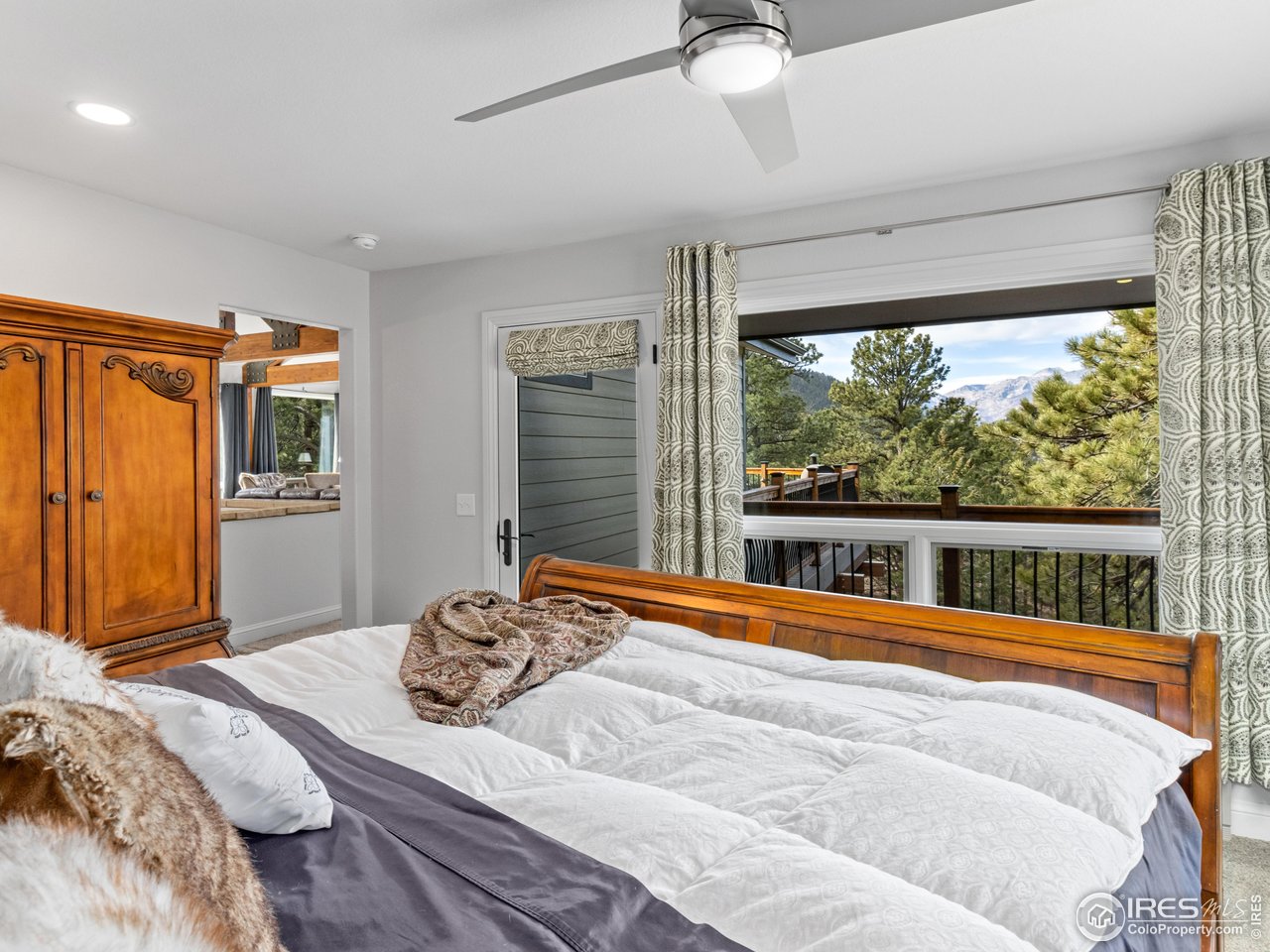 1267 Upper Venner Road Estes Park, CO 80517 - Photo 12 of 44 a bedroom with a bed and a large window