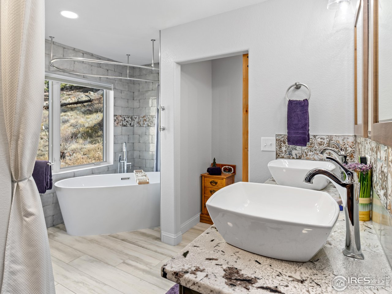 1267 Upper Venner Road Estes Park, CO 80517 - Photo 14 of 44 a bathroom with a tub sink and mirror