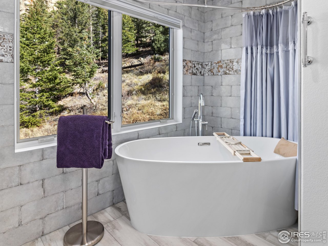 1267 Upper Venner Road Estes Park, CO 80517 - Photo 15 of 44 a white bath tub sitting in a bathroom next to a window
