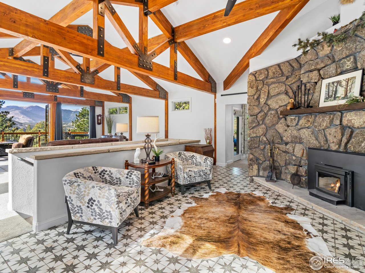 1267 Upper Venner Road Estes Park, CO 80517 - Photo 20 of 44 a outdoor living space with patio furniture and a fireplace