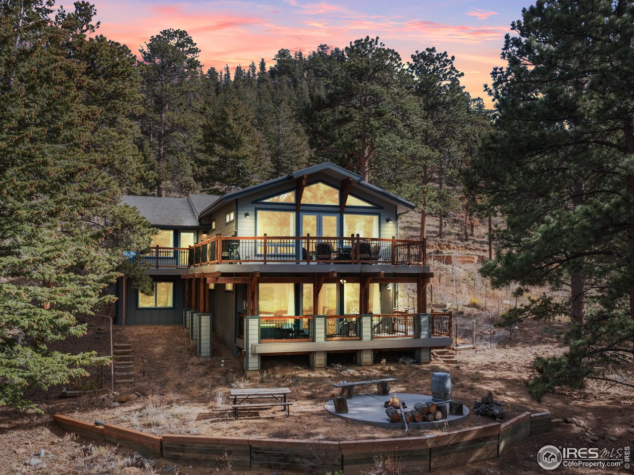 1267 Upper Venner Road Estes Park, CO 80517 - Photo 22 of 44 Twilight View of Back of home. The sunsets from these windows are spectacular!