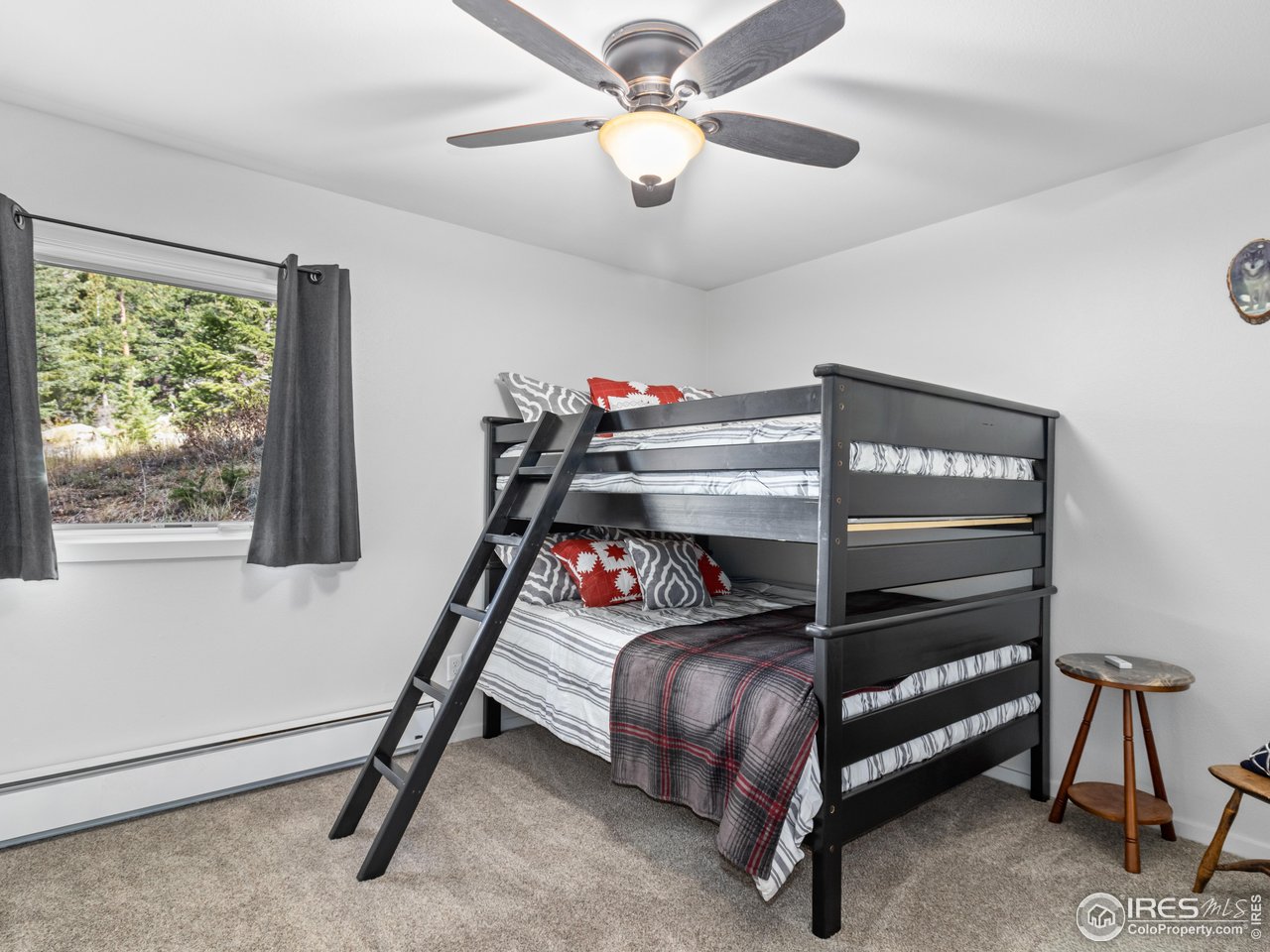 1267 Upper Venner Road Estes Park, CO 80517 - Photo 26 of 44 a bedroom with a bed and a chandelier