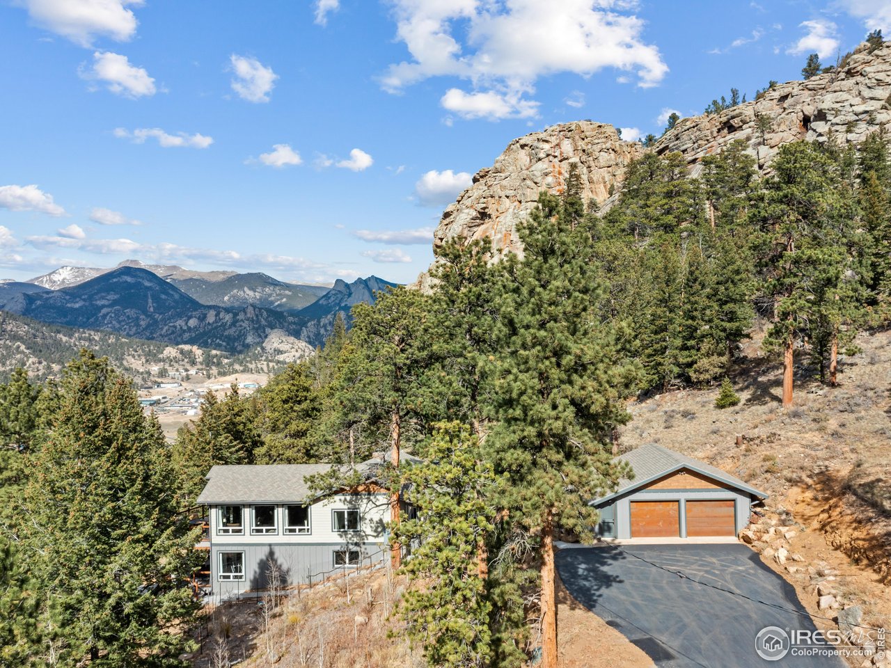 1267 Upper Venner Road Estes Park, CO 80517 - Photo 32 of 44 a view of a large building with a mountain in the background