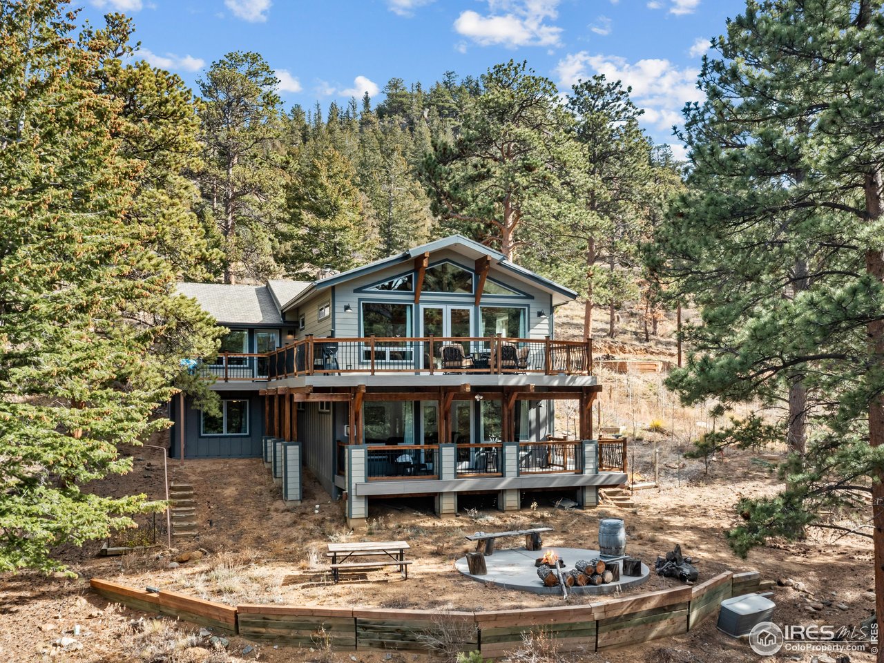 1267 Upper Venner Road Estes Park, CO 80517 - Photo 4 of 44 Back View of home - Upper wrap around trex deck and lower level trex deck. Concrete pad and firepit for enjoying the cool nights
