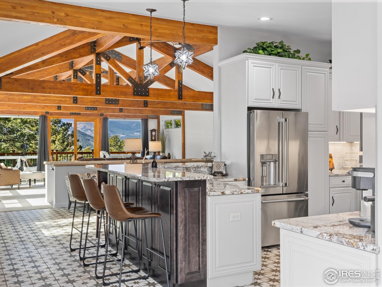 1267 Upper Venner Road Estes Park, CO 80517 - Photo 7 of 44 Imagine breakfasts here! Premium GE Cafe Collection Appliances. Designer North Star light fixtures and matching flooring elevate the style. Dovetail Drawers and extra cabinetry under the peninsula maximize storage.