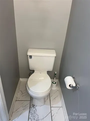 a white toilet sitting next to a white sink