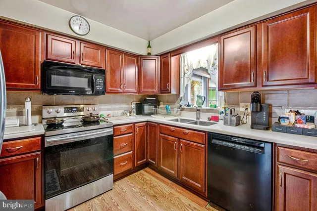 a kitchen with stainless steel appliances granite countertop a stove sink microwave and cabinets