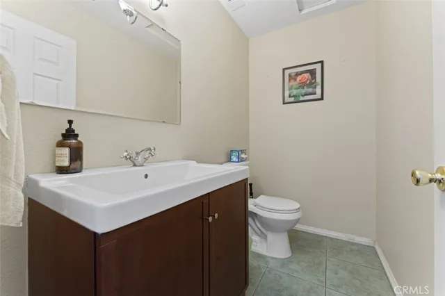 a bathroom with a sink a toilet and mirror