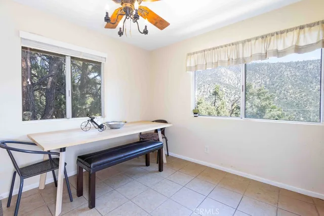 a view of a workspace with furniture and window