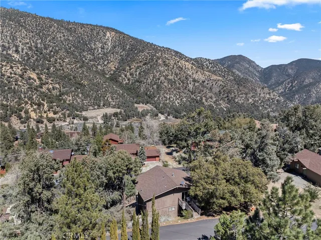 a view of a house with a mountain in the background