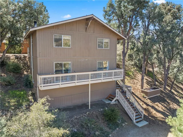 a balcony with wooden fence and a bench