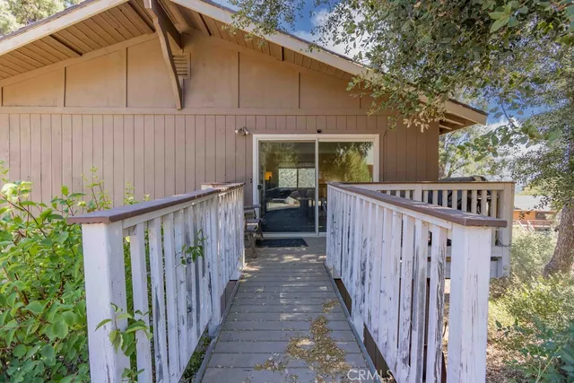 a view of a house with wooden fence