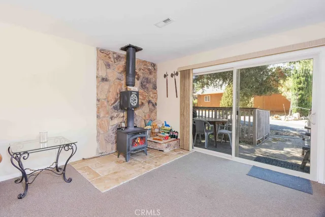 a bedroom with furniture and a floor to ceiling window