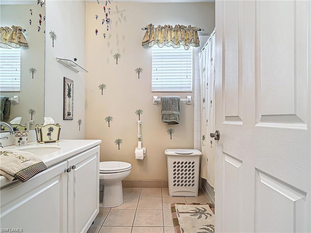 1680 Sanctuary Pointe Court Naples, FL 34110 - Photo 11 of 20 a bathroom with a sink toilet and shower