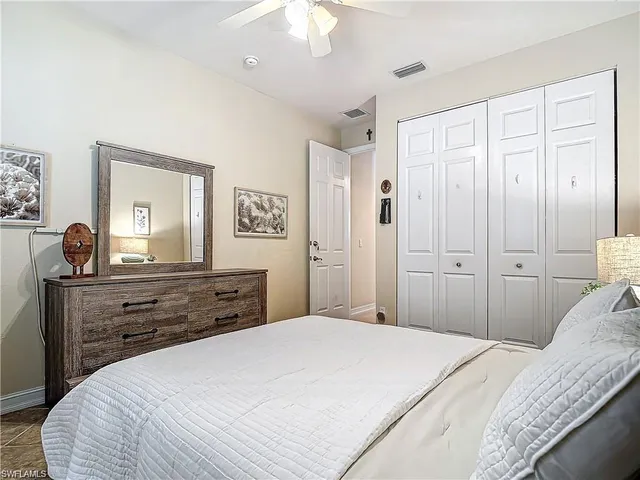 a bedroom with a bed and a dresser