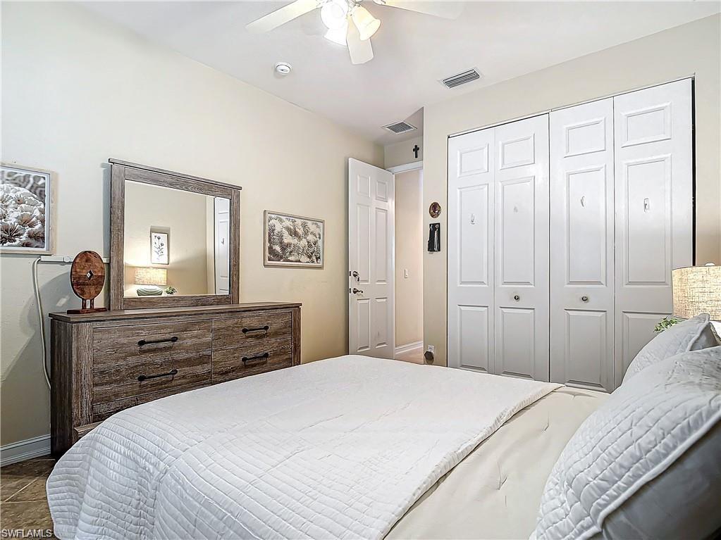 1680 Sanctuary Pointe Court Naples, FL 34110 - Photo 12 of 20 a bedroom with a bed and a dresser