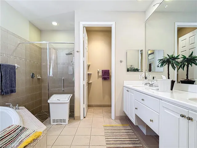 a spacious bathroom with a double vanity sink toilet and shower