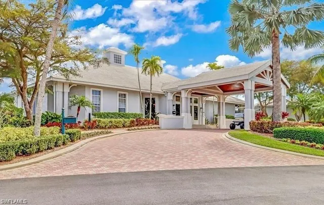 a front view of a house with a garden and plants