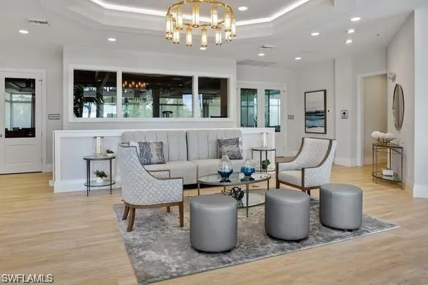 a living room with furniture and a chandelier