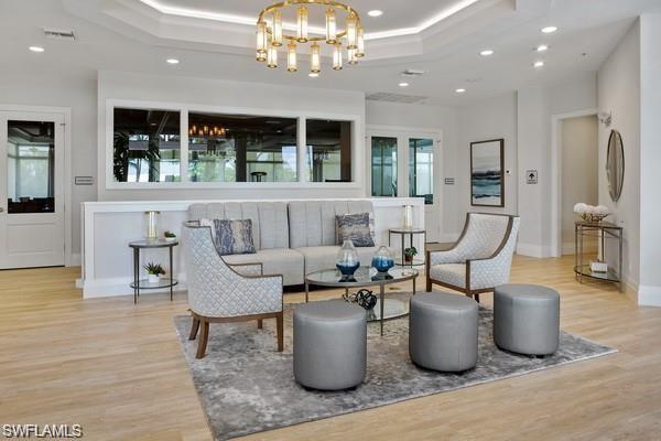 1680 Sanctuary Pointe Court Naples, FL 34110 - Photo 19 of 20 a living room with furniture and a chandelier