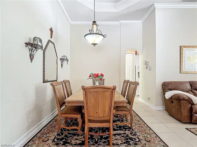 a dining room with furniture and chandelier