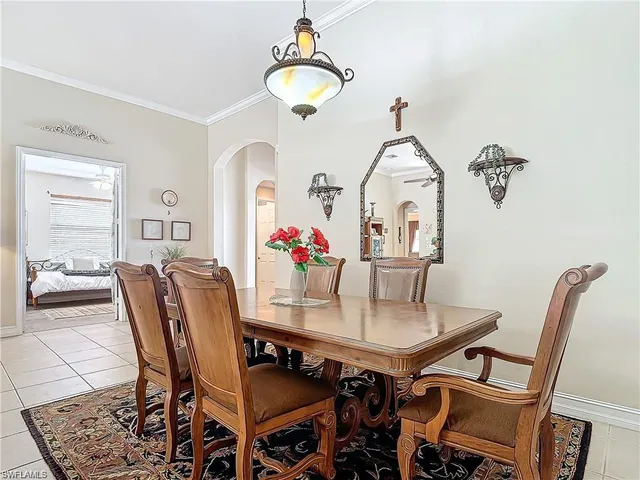 a view of a dining room with furniture and a chandelier