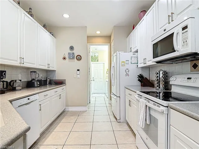 a kitchen with stainless steel appliances granite countertop a sink and a stove