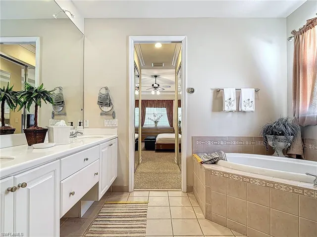 a en suite bathroom with double vanity and a mirror