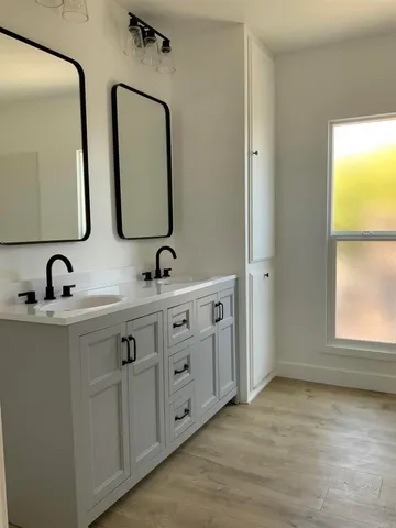 a bathroom with 2 sink and a mirror