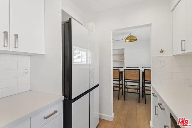 a view of kitchen with cabinets and wooden floor